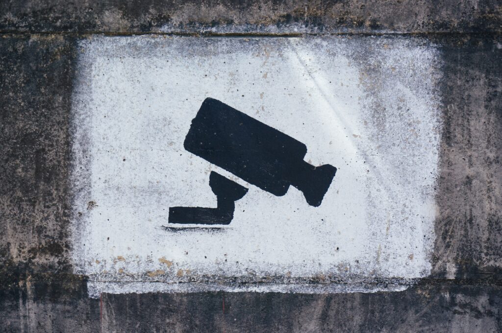 A painting on a wall warning visitors and potential thefts about video surveillance